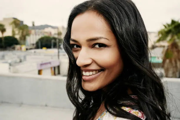 files/indian-woman-smiling-on-urban-rooftop_1.webp